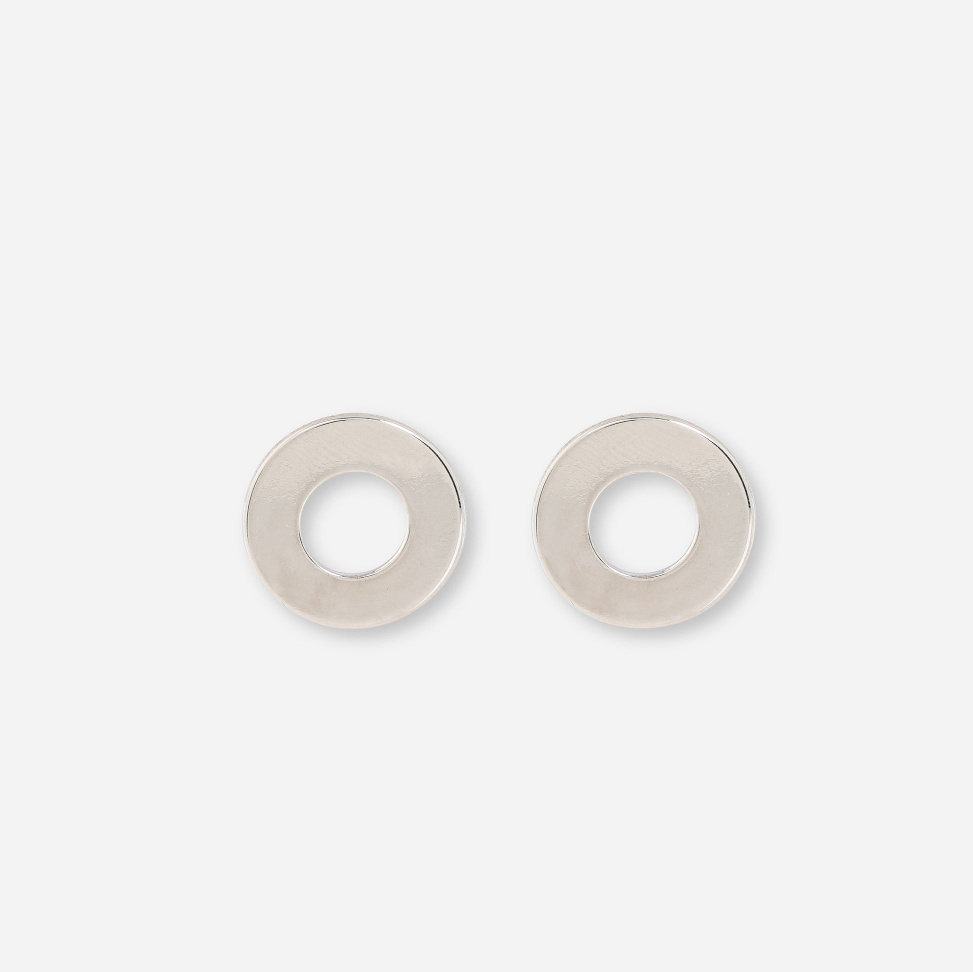 Silver circular stud earrings offer classic and versatile accessory option. 