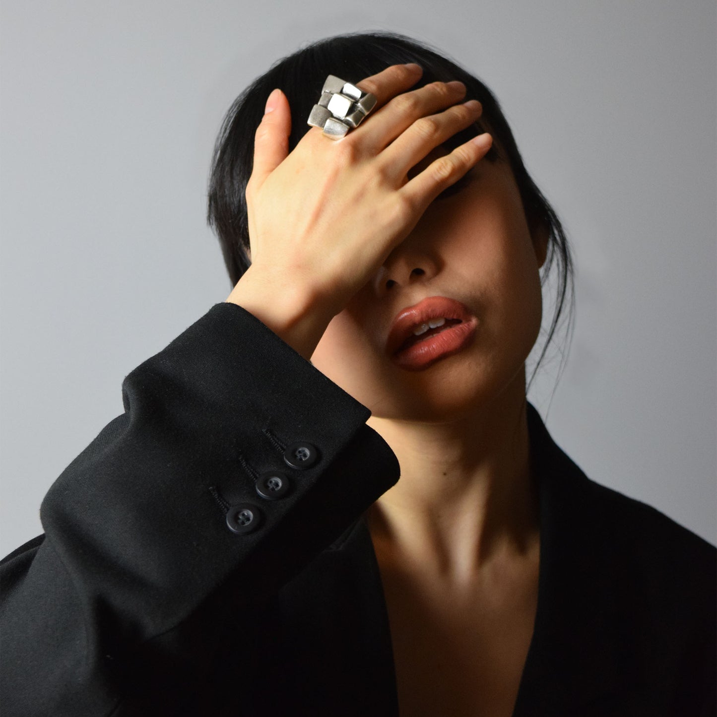 Model wearing Gigi Ring with oversized black jacket